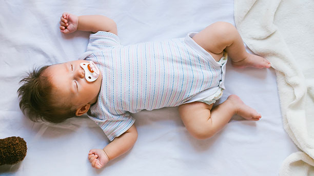 Baby sleeping on a mattress