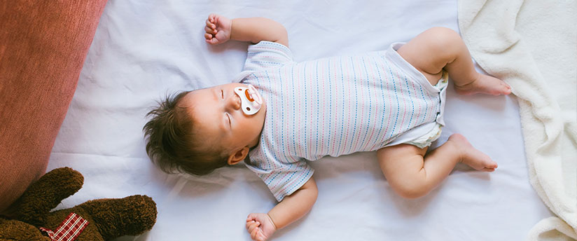 Comfortable baby sleeping on a mattress